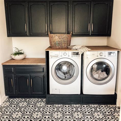 white cabinets with black stainless steel laundry|black cabinets with white base.